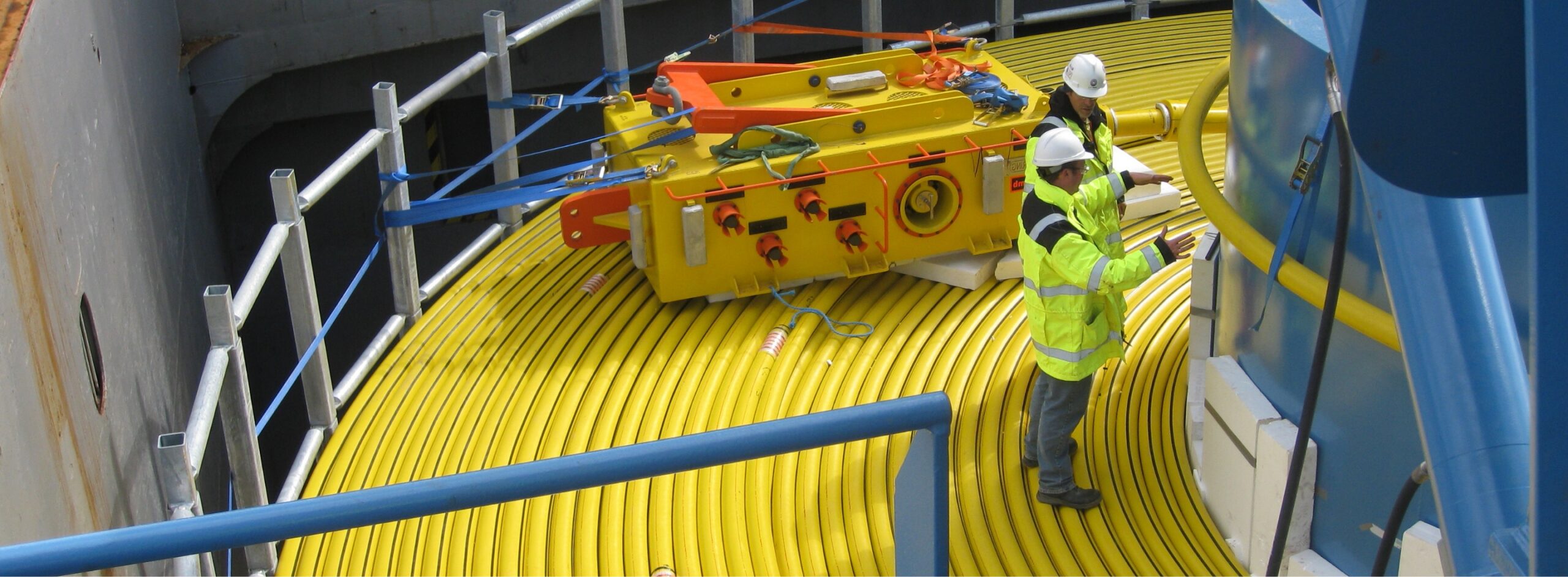 Two men standing on a cable carousell