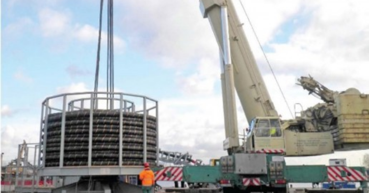 Crane lifting a spare cable carousel